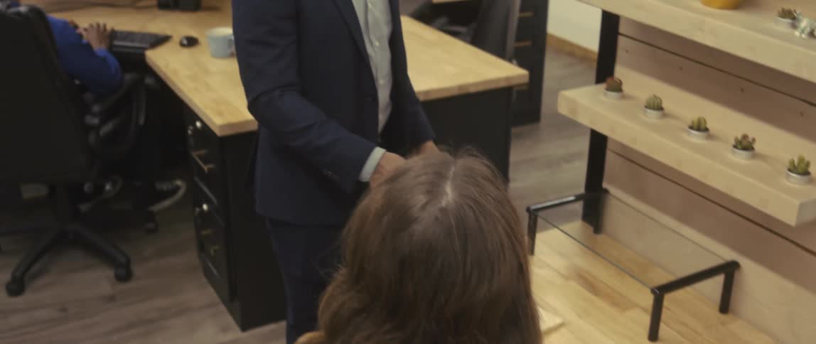Man and a woman talking in an office environment