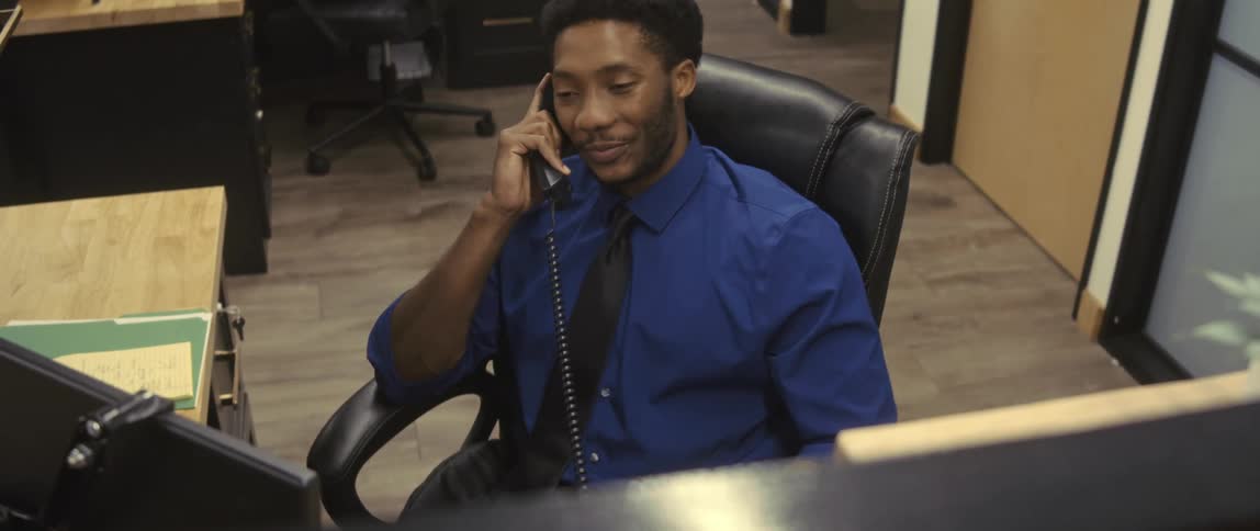 Man talking on phone in an office environment