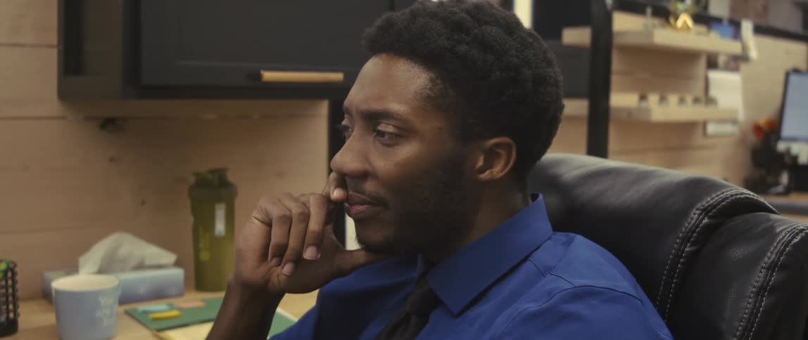 Portrait of a man sitting on a chair in an office environment