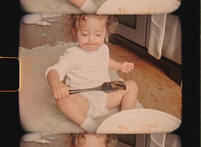 Super 8 film of a toddler who scoops a spoonful of baking mix from a large bowl