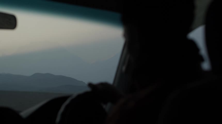 A person is driving on a foggy day