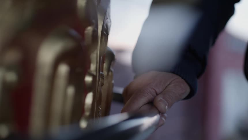 Persons hand resting on a metal handrail