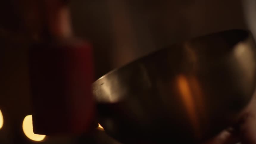 A man polishes a metal pot with a rolling device