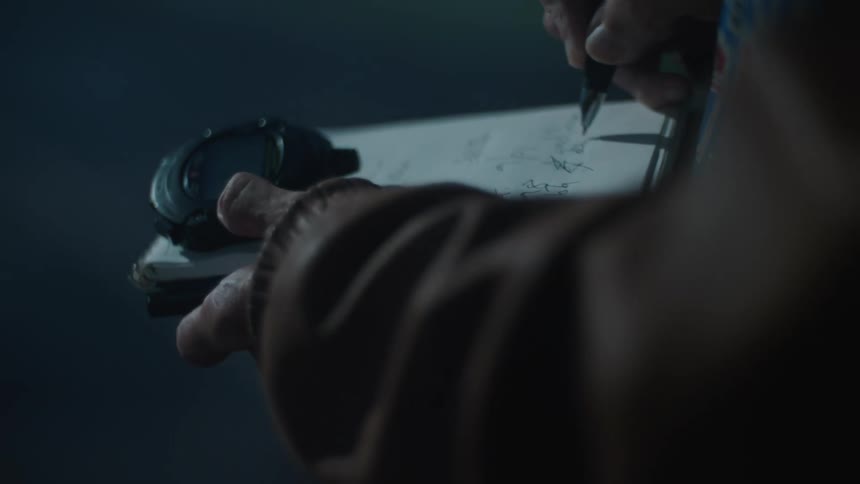 Persons hand writing on a clipboard