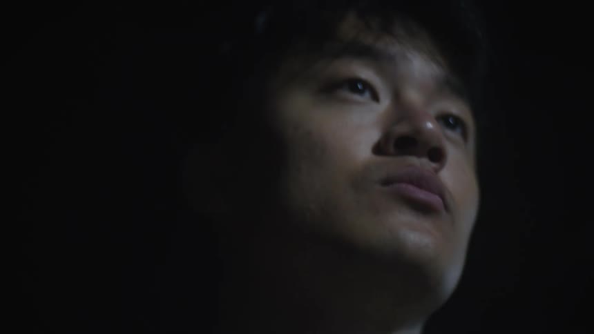 Portrait of a young man in a dark environment