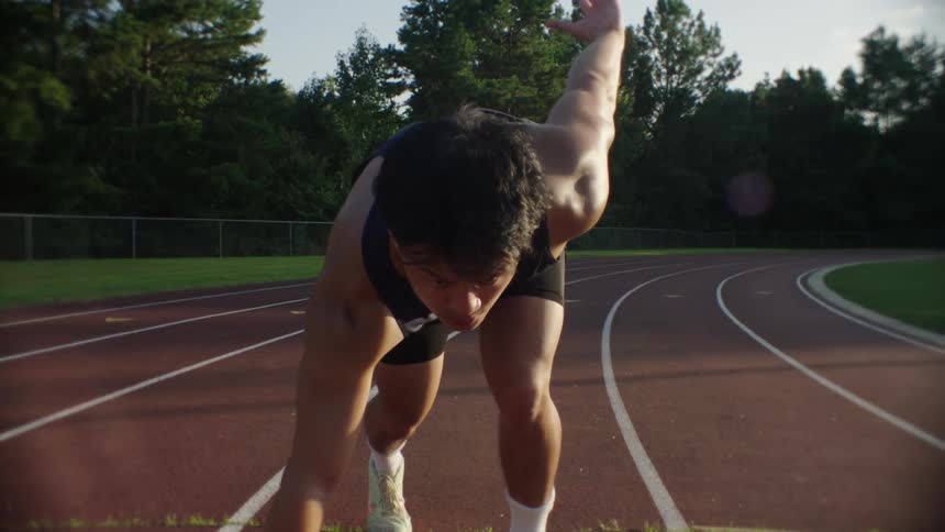 A clip of a male athlete running on the track