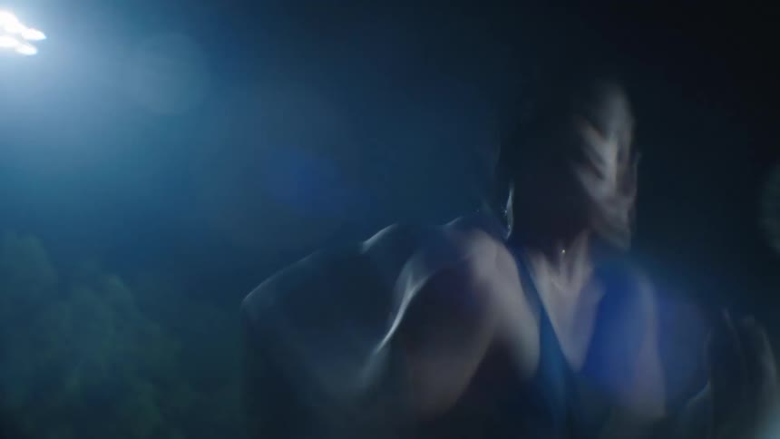 A man is running at night on the track