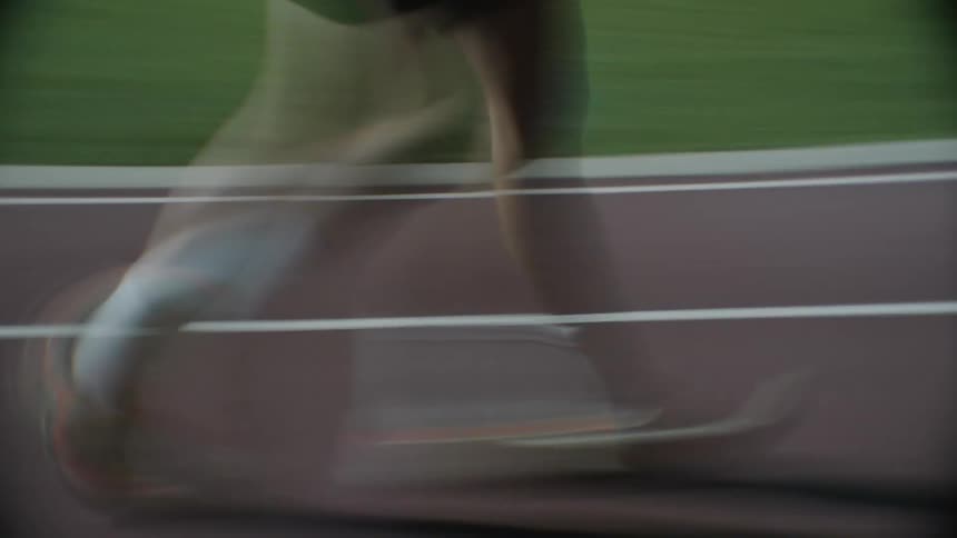 Legs of a person running on a track