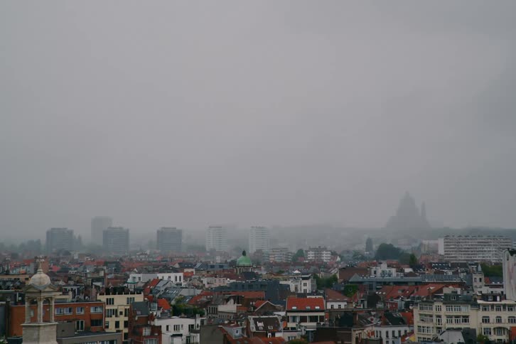 Suburbs sit near a downtown city area on a smoggy day