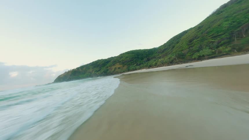 A fast revealing footage of a beach side with an fpv drone