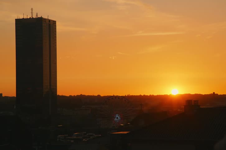 The sun is rising on the tower