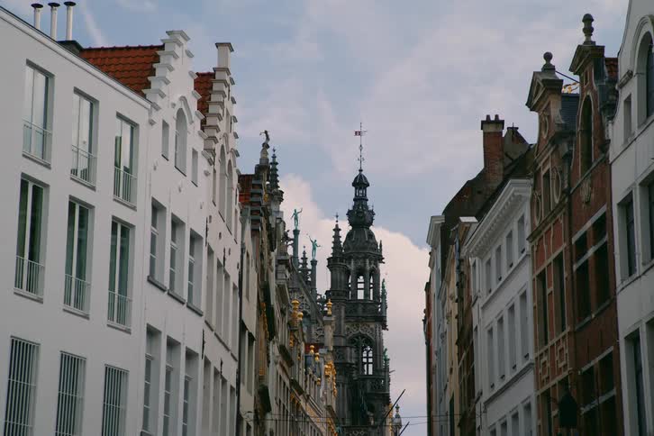 A tall tower is at the end of the block