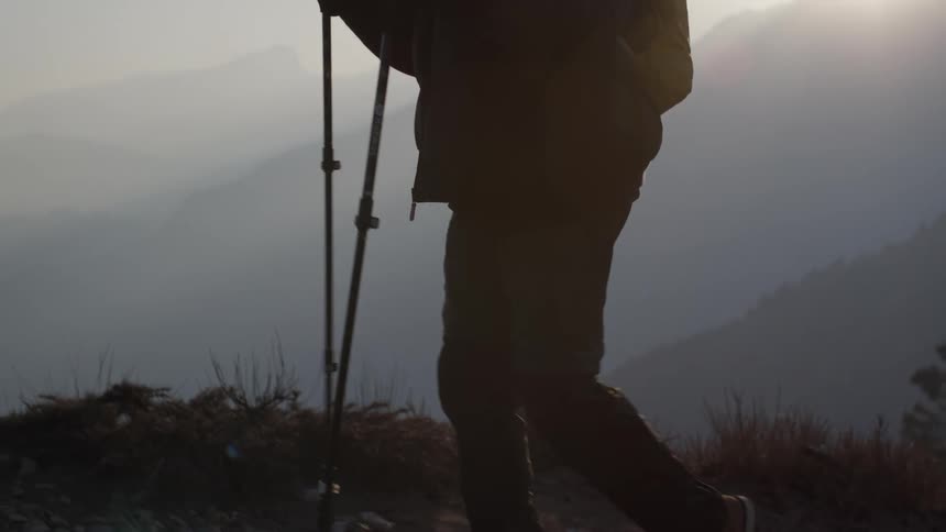 A man is hiking on the fog covered mountain