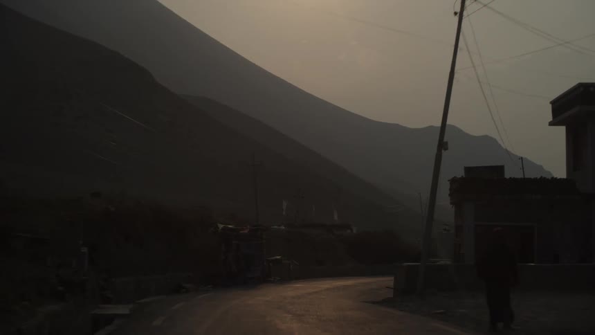A run down poor community is shown through a persons point of view as they travel down the road within it