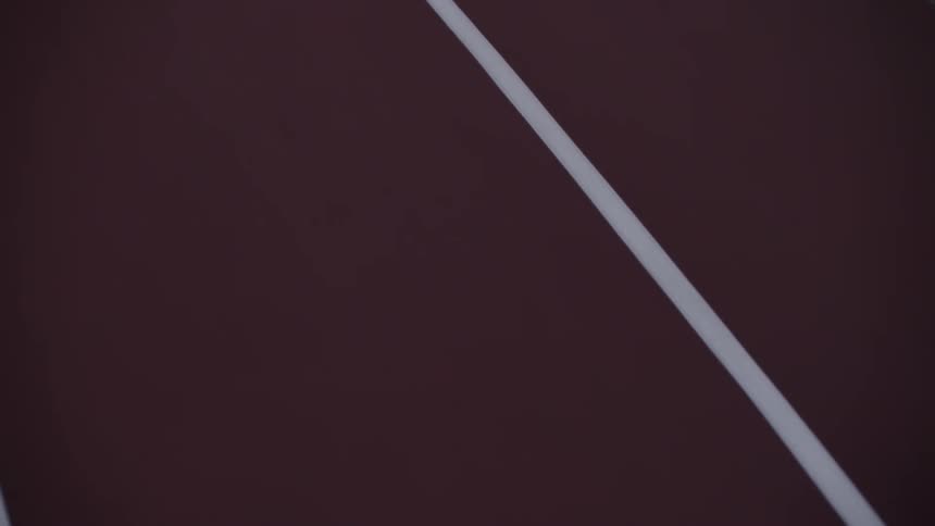 The floor of a red race track with white lines