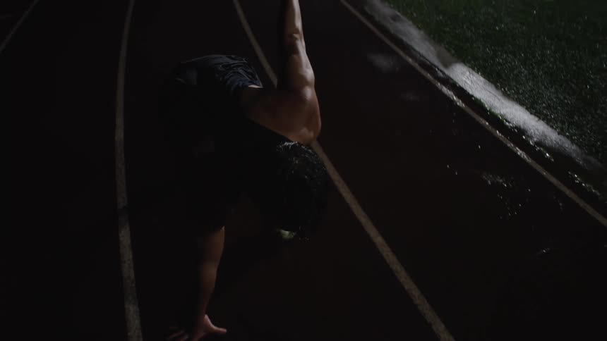 A runner gets ready on the track