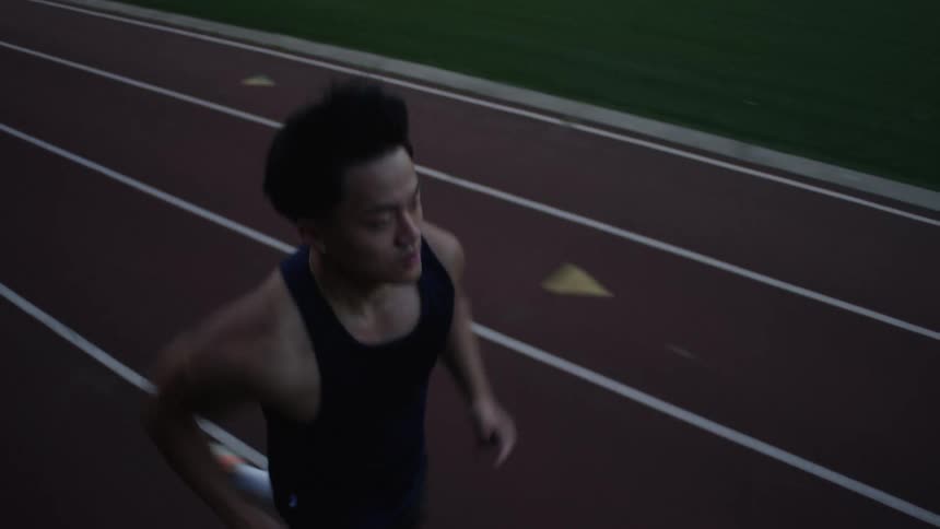 Man running on an athletics track