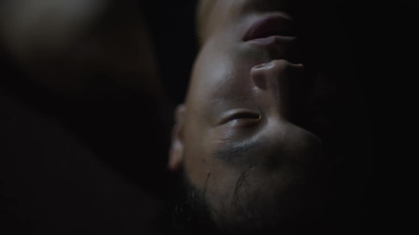 A man is resting in the dark