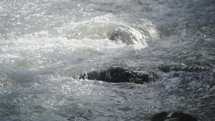 River water tumbles over a rocky rapid
