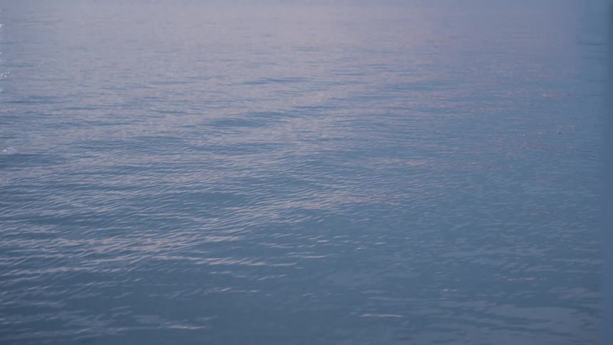 Gentle waves flow across the surface of the ocean during the day