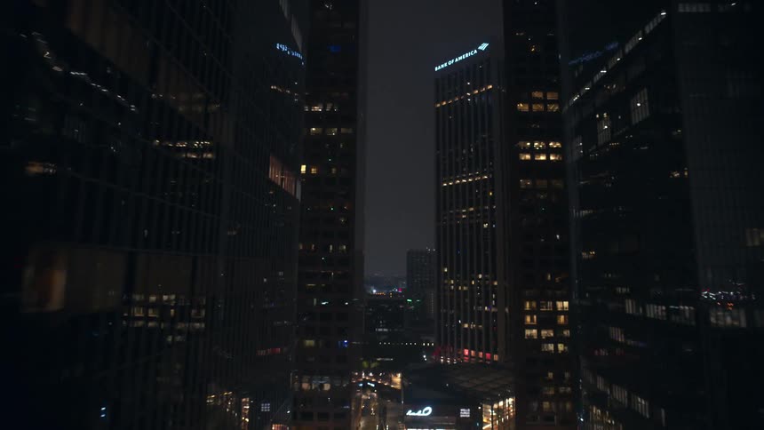 Large skyscrapers dominate a city skyline at night