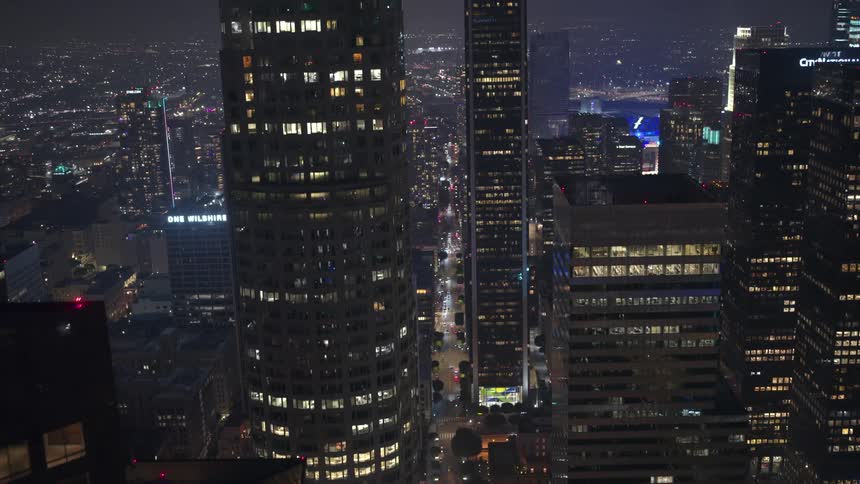 Aerial of skyscrapers in a downtown metropolis at night