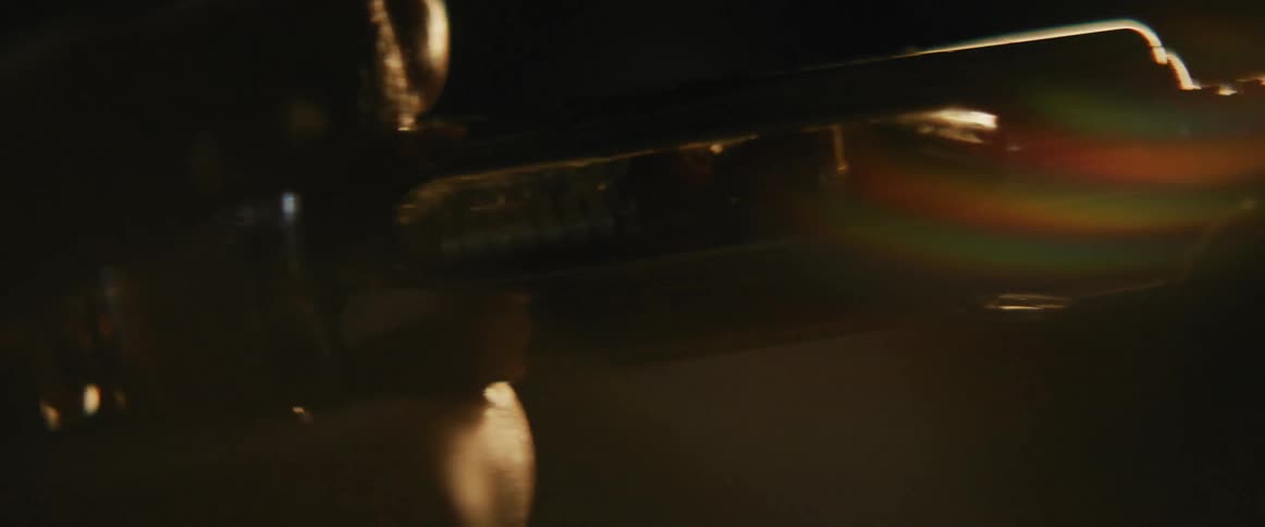 Close up of a syringe pumping liquid in a dimly lit environment