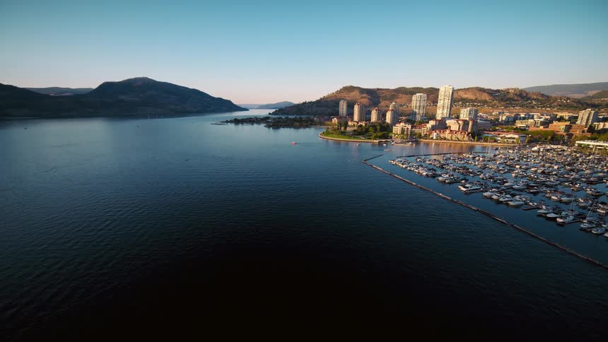 A large marina for boats sits offshore of a city