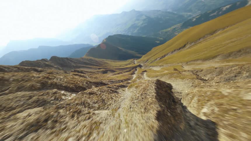 An aerial revealing clip of a sloppy mountain land