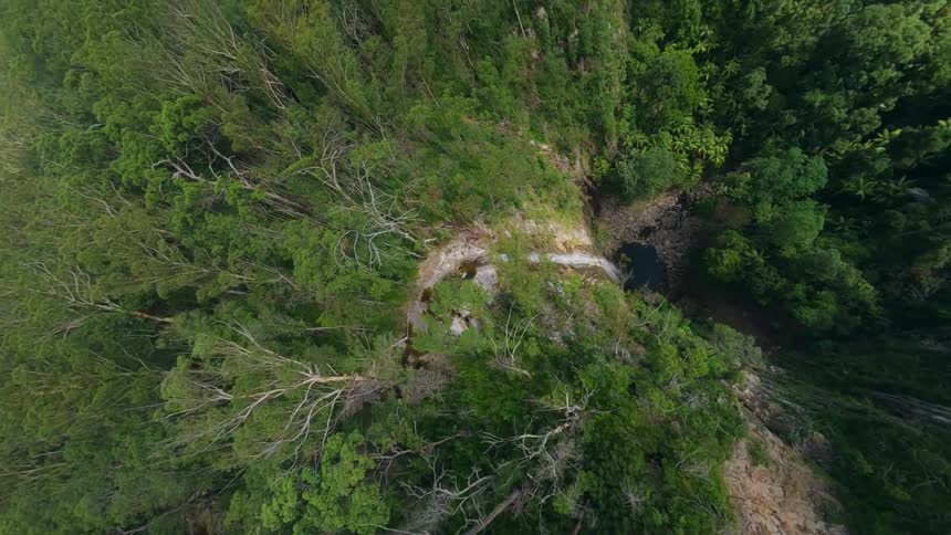 An aerial fpv drone dive down a big waterfall