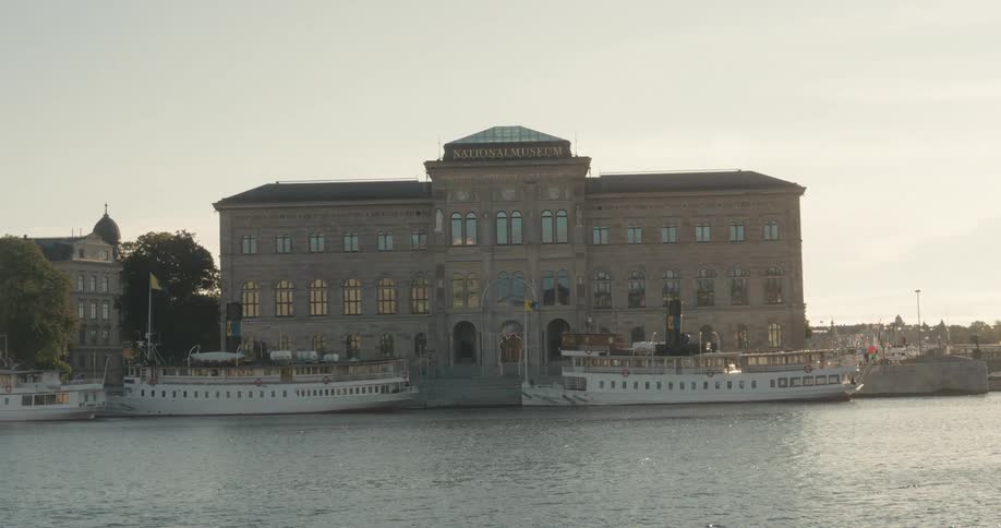 Boats moored next to a classical building