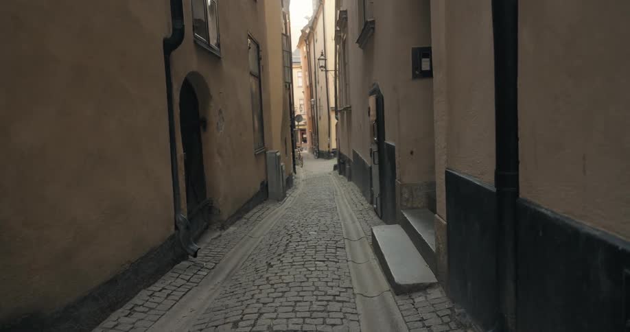 Narrow alley between old and classical buildings of a city