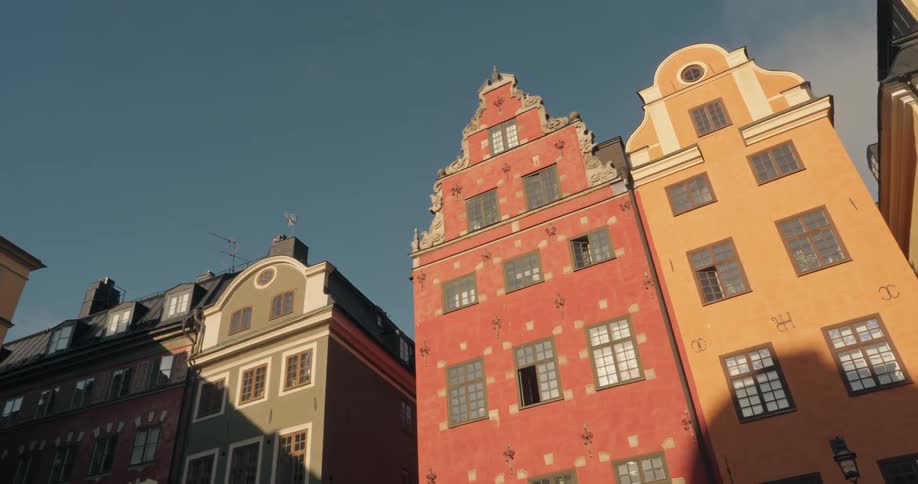 Some old apartment buildings of different colors and with lots of windows