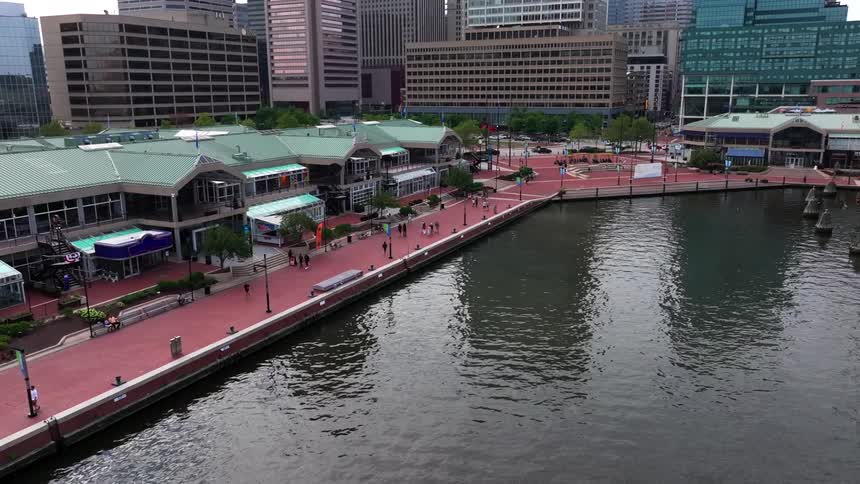 Pedestrians walk along the waterfront near downtown