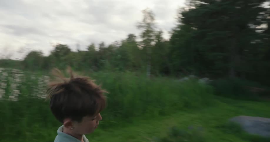 Boy running and playing on the edge of a lake