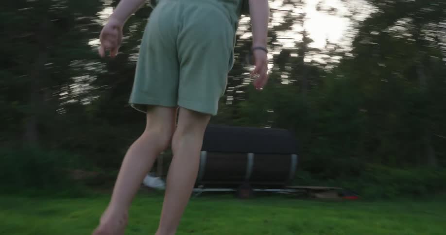 A child runs around and jumps on a rock