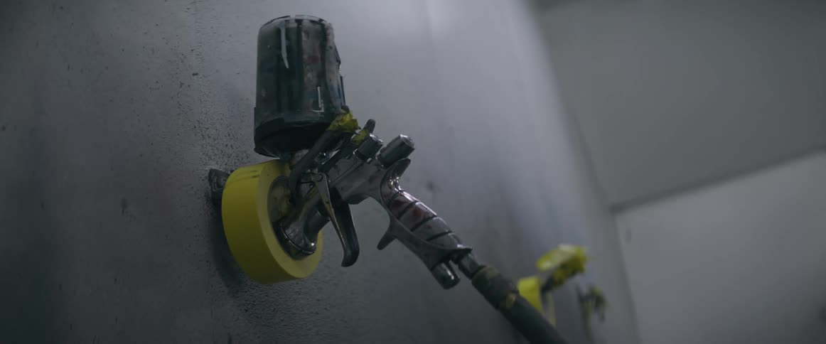 Mechanical hands hold a long handled tool