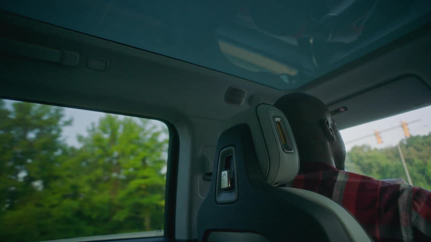 A man is driving his vehicle