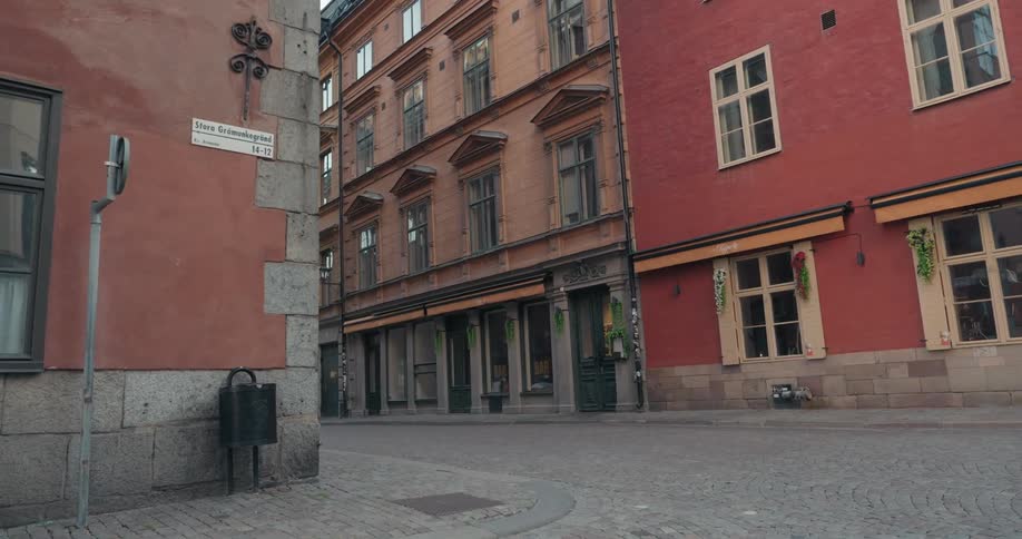 Cobblestone street in an urban city surrounded by classical buildings