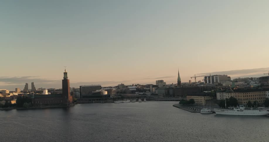 A picturesque aerial cityscape with calm waters reflecting a golden sky