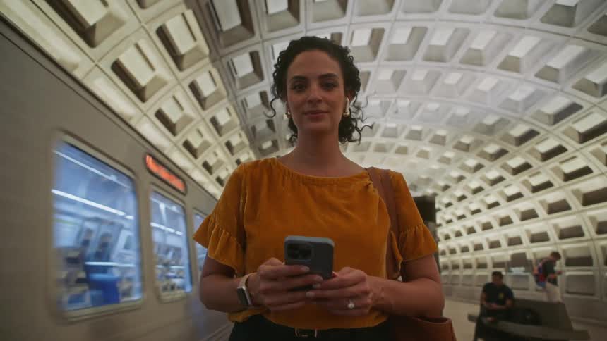 The train rides past the woman