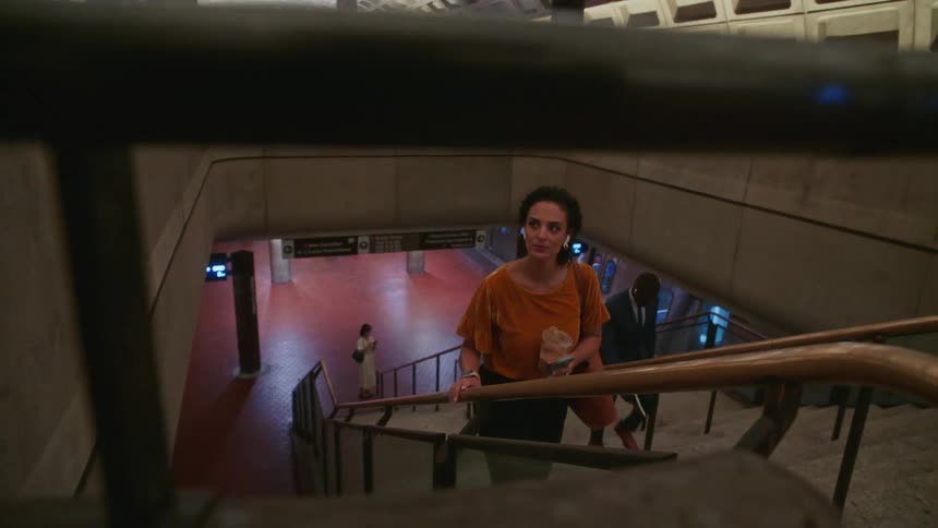 Woman climbing the stairs of a terminal