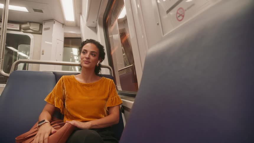 Female passenger sitting on a train bench