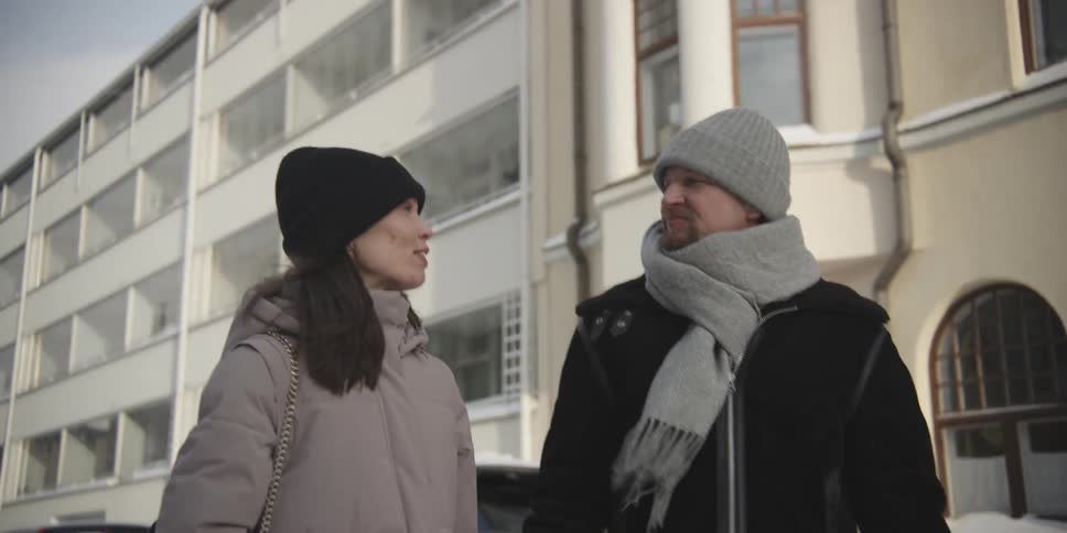 Couple holding hands walking through a residential neighborhood happily