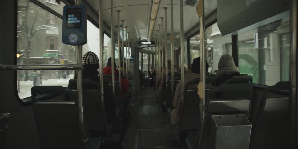 Passengers sitting on the seats of a bus moving through the city