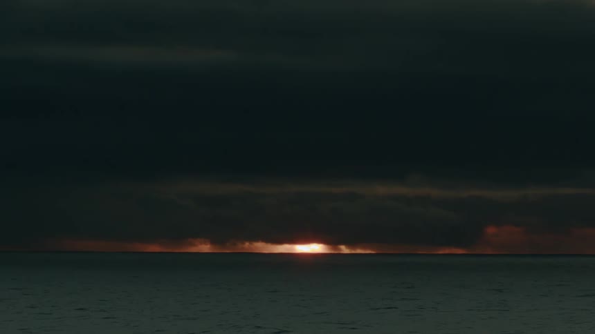 Ocean landscape with stormy sunset on the horizon