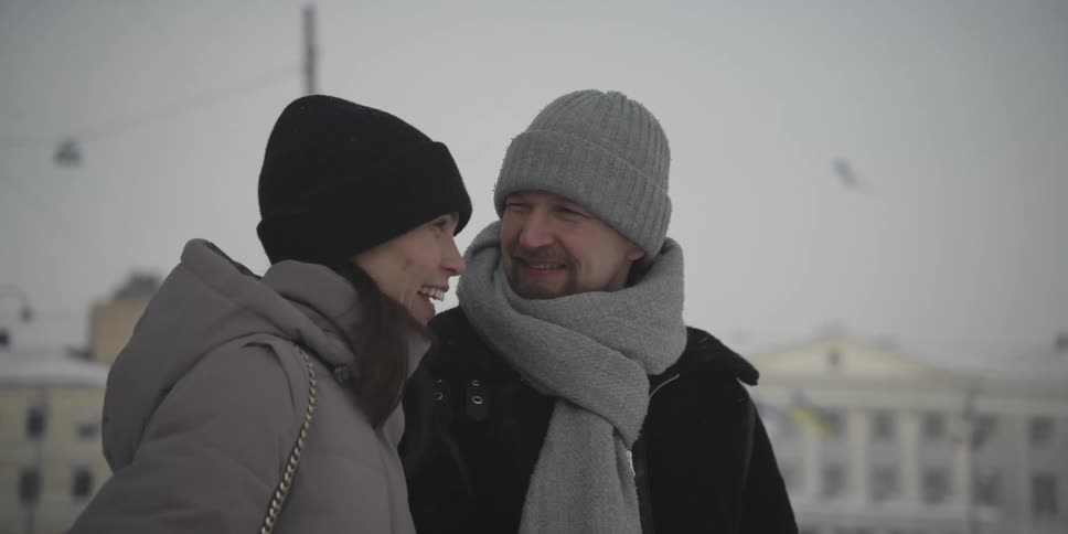 Portrait of a couple in warm clothing in an outdoor setting in the city
