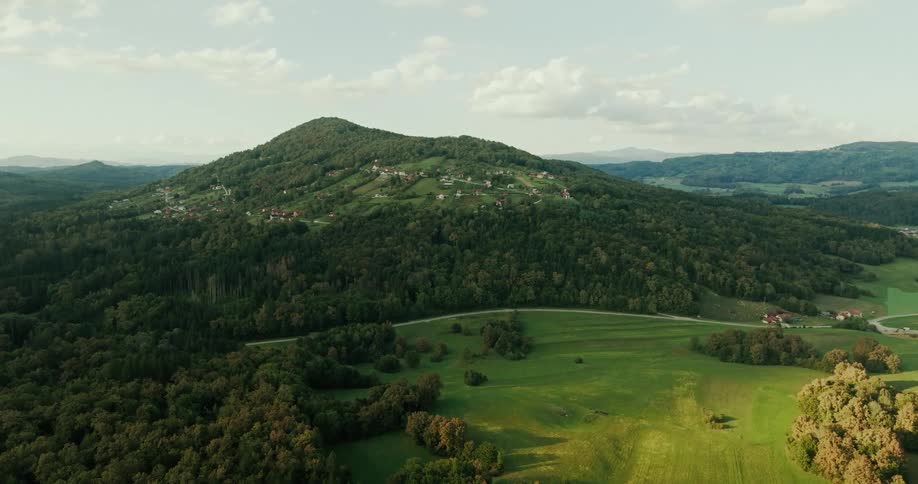 Aerial of a rural village on a forested mountain