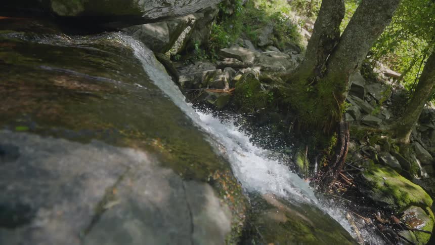 Water from a river falling over rocks in the forest