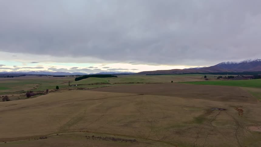 Expansive rural landscape with fields in various shades of brown and green